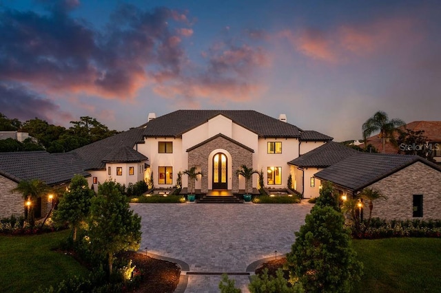 570 Manor Rd, Maitland, FL 32751 - french country style house with a front lawn, a tile roof, a chimney, and stucco siding