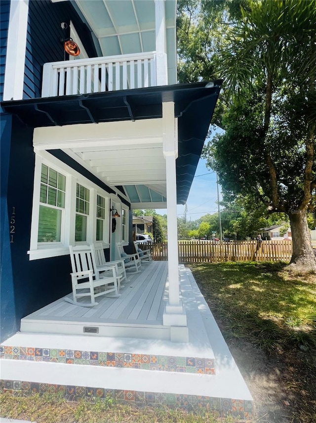 deck with fence and a porch