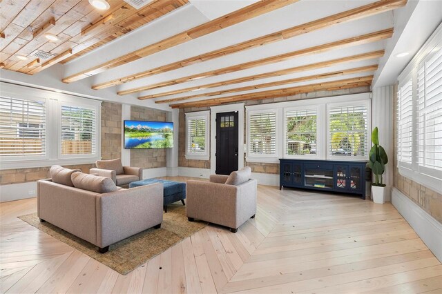 living area with plenty of natural light and beamed ceiling