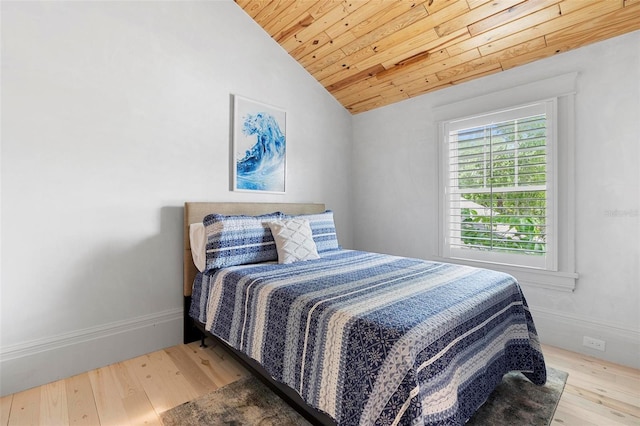 bedroom with wooden ceiling, wood finished floors, vaulted ceiling, and baseboards