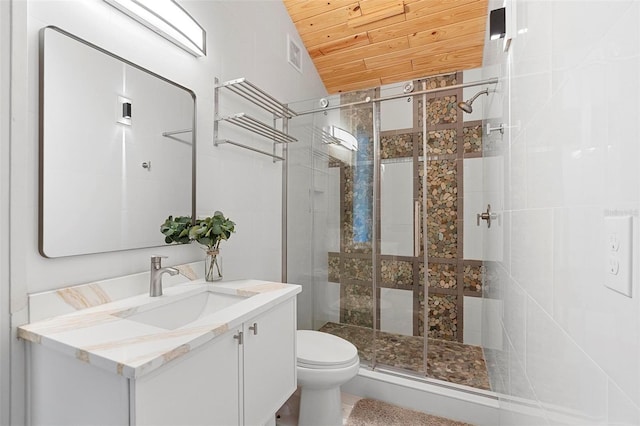 bathroom featuring wooden ceiling, a stall shower, toilet, vanity, and vaulted ceiling