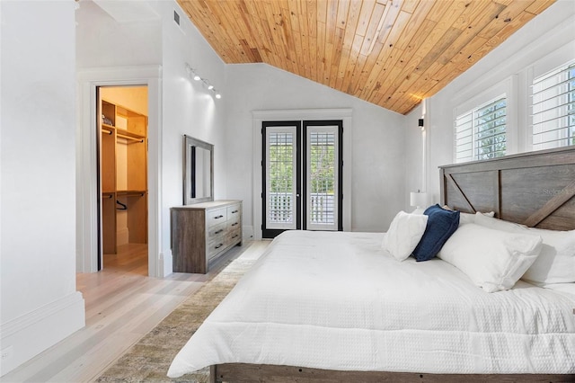 bedroom with multiple windows, light wood-style flooring, lofted ceiling, access to exterior, and wooden ceiling