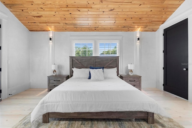 bedroom with wooden ceiling, wood finished floors, lofted ceiling, and baseboards