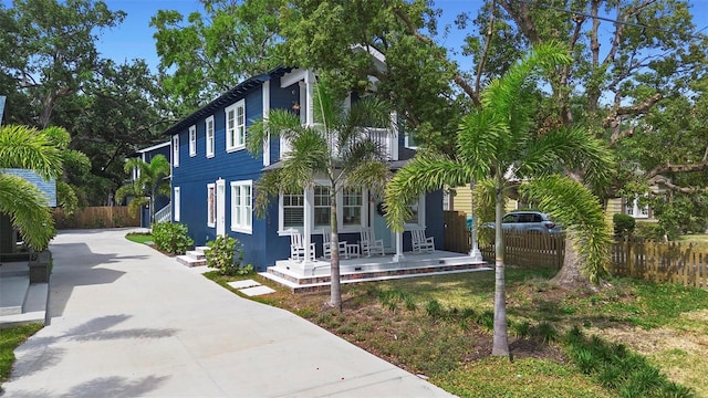view of home's exterior with fence and driveway
