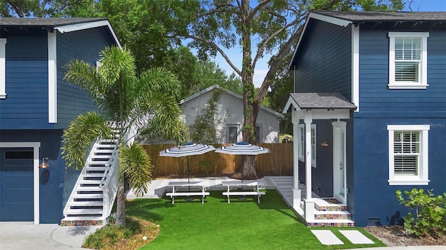 view of front of property featuring stairs and stucco siding