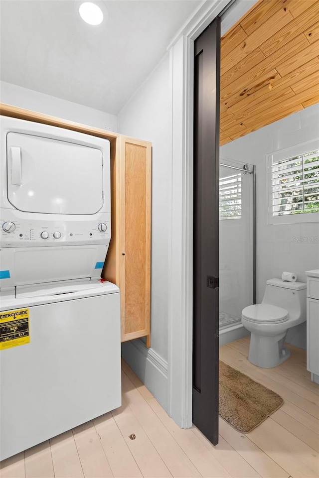 laundry area with stacked washer / drying machine