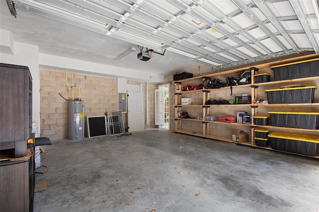 garage featuring water heater, electric panel, a garage door opener, and concrete block wall