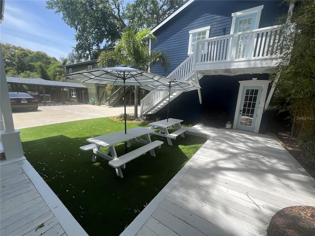 back of house featuring a wooden deck, stairway, and a yard