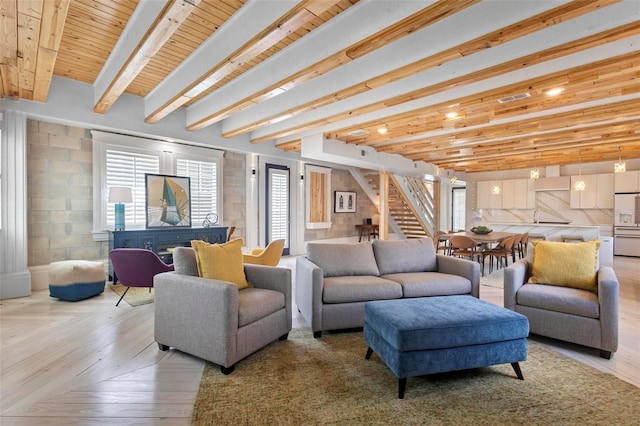 living room with stairs, beamed ceiling, and wood ceiling