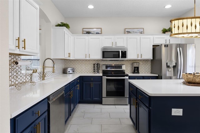 kitchen with blue cabinetry, white cabinetry, and stainless steel appliances