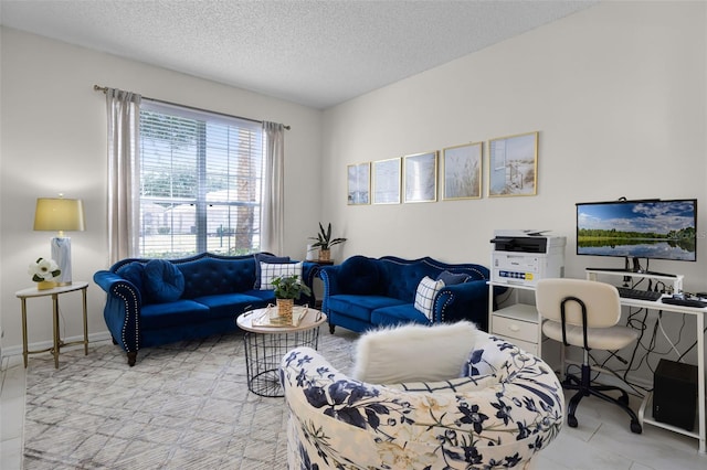 living area with a textured ceiling and light tile patterned floors