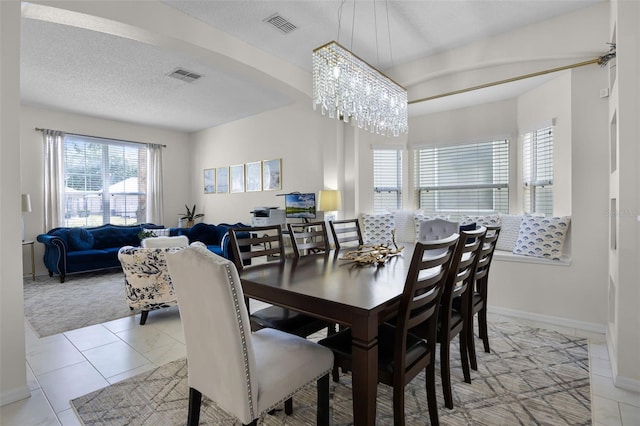 dining area with baseboards, a chandelier, and visible vents