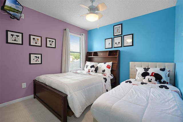 bedroom with carpet floors, a ceiling fan, a textured ceiling, and baseboards