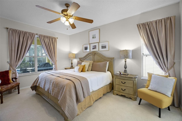 bedroom with baseboards, light colored carpet, and ceiling fan