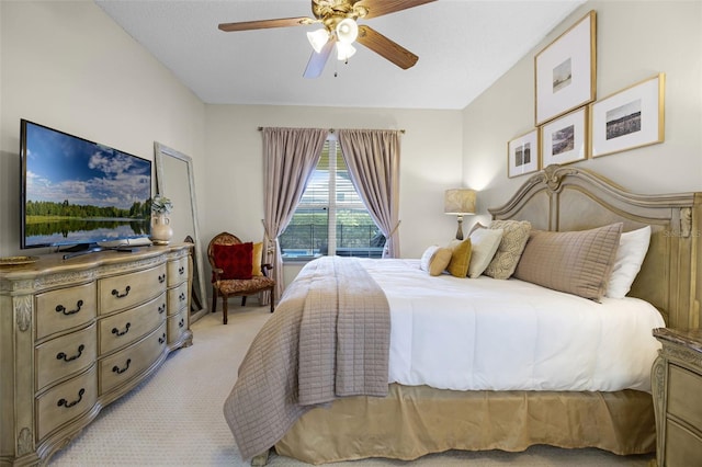 bedroom with a ceiling fan and light colored carpet