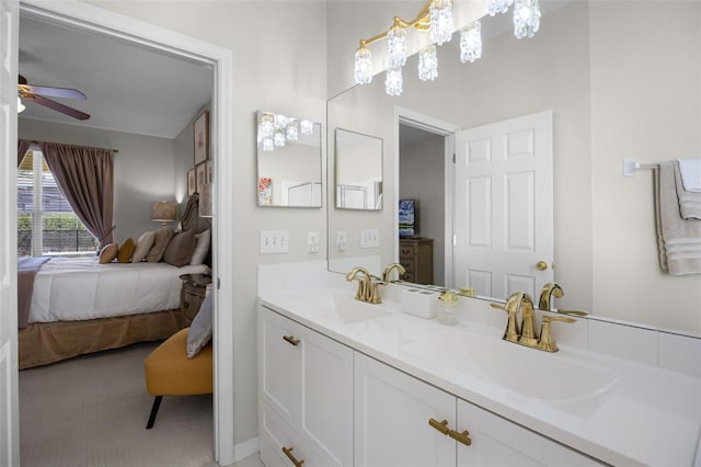 bathroom with connected bathroom, a ceiling fan, a sink, and double vanity