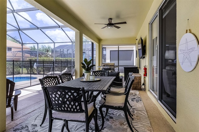 view of patio / terrace featuring glass enclosure, ceiling fan, a fenced in pool, and outdoor dining area