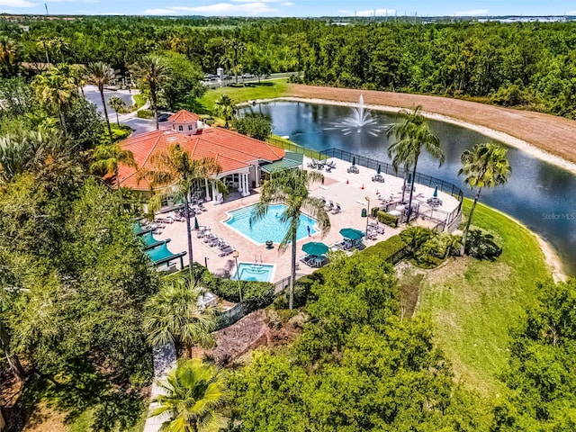 drone / aerial view with a water view and a view of trees