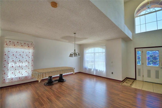 foyer entrance featuring a wealth of natural light, wood finished floors, and a textured ceiling