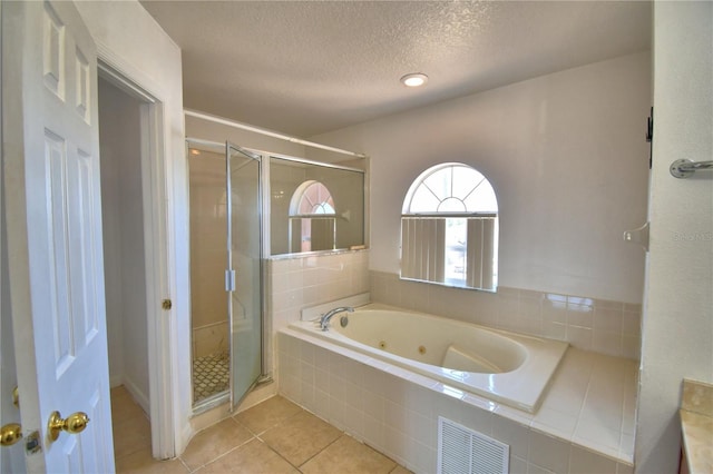 full bathroom with a shower stall, tile patterned flooring, a whirlpool tub, visible vents, and a textured ceiling