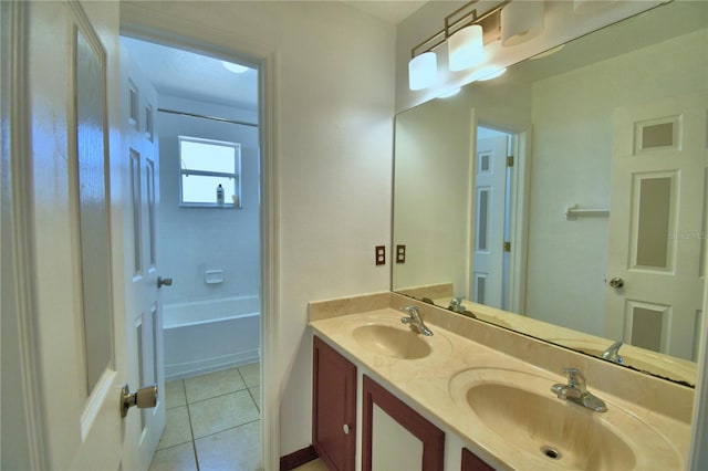 bathroom with tile patterned floors, a sink, and double vanity