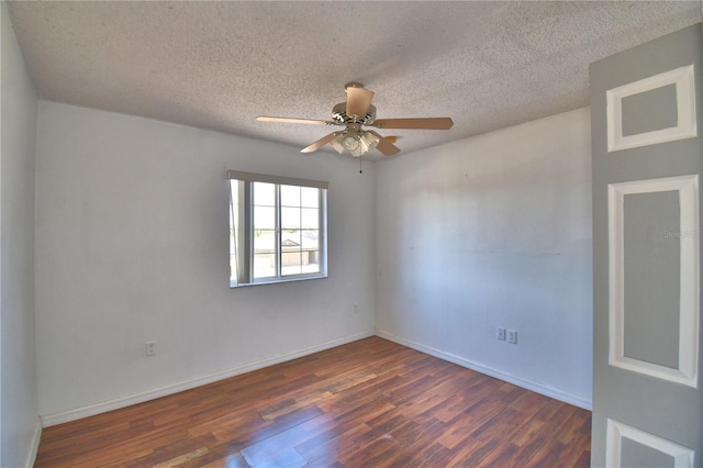 spare room featuring ceiling fan, baseboards, wood finished floors, and a textured ceiling