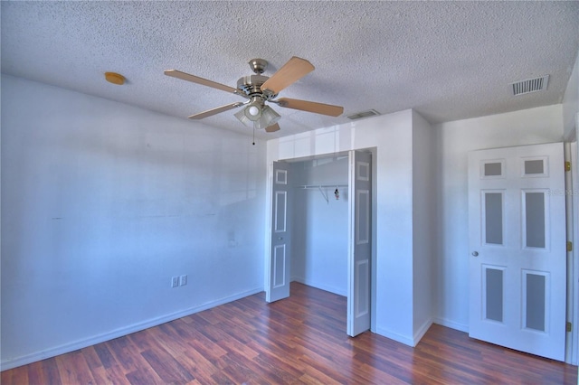 unfurnished bedroom featuring baseboards, visible vents, and dark wood-style floors