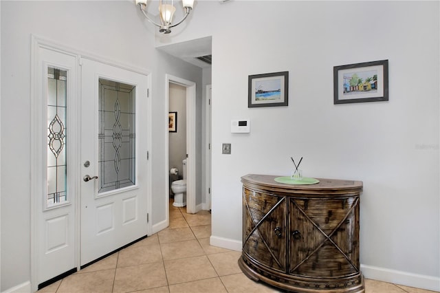 4833 Palm Tree Ct, Windermere, FL 34786 - foyer entrance with baseboards, light tile patterned floors, and a chandelier