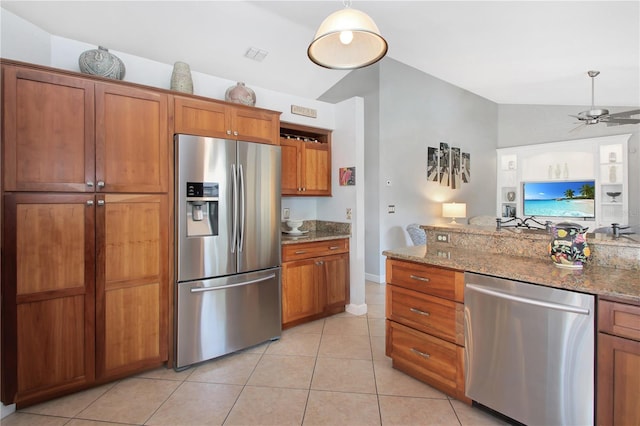 4833 Palm Tree Ct, Windermere, FL 34786 - kitchen with stainless steel appliances, brown cabinets, vaulted ceiling, and a ceiling fan