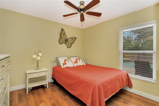4833 Palm Tree Ct, Windermere, FL 34786 - bedroom with wood finished floors, baseboards, and a ceiling fan
