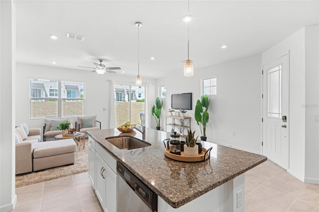 kitchen featuring a sink, open floor plan, dishwasher, and a healthy amount of sunlight