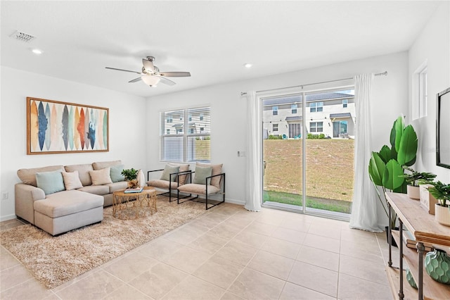 living area featuring ceiling fan, recessed lighting, visible vents, and light tile patterned floors