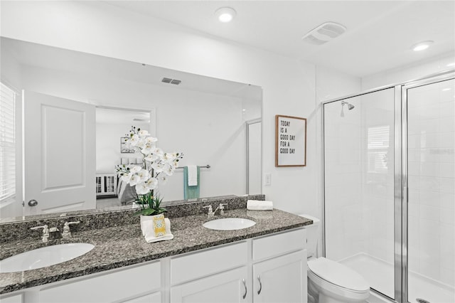 full bathroom featuring a sink, visible vents, toilet, and a stall shower
