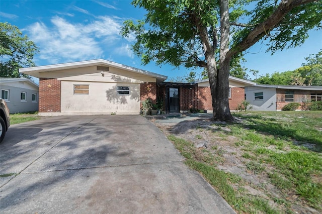 1136 Lakewood Park Dr, Daytona Beach, FL 32117 - single story home featuring concrete driveway and brick siding