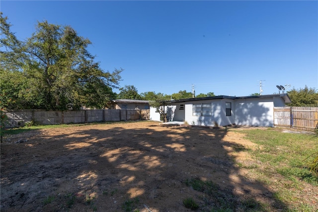 rear view of property with a fenced backyard