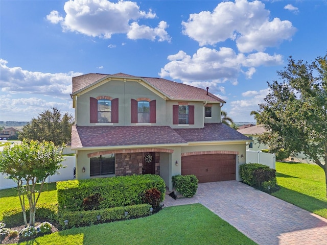 4113 Longbow Dr, Clermont, FL 34711 - view of front of property featuring stucco siding, decorative driveway, and a garage
