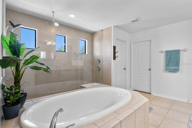 4113 Longbow Dr, Clermont, FL 34711 - bathroom with healthy amount of natural light, a garden tub, a tile shower, and recessed lighting