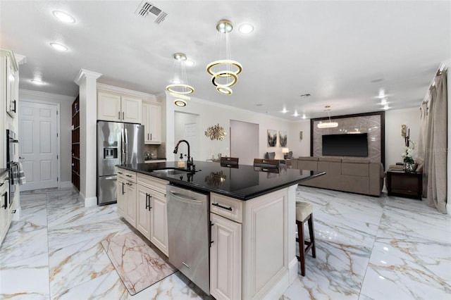 8625 Brixford St, Orlando, FL 32836 - kitchen with ornamental molding, open floor plan, a center island with sink, stainless steel appliances, and a sink