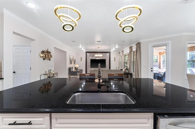 8625 Brixford St, Orlando, FL 32836 - kitchen with open floor plan, dark stone countertops, a sink, and white cabinetry