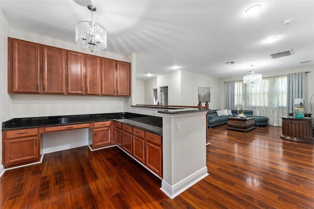 8625 Brixford St, Orlando, FL 32836 - kitchen featuring dark wood-style flooring, an inviting chandelier, open floor plan, a peninsula, and visible vents