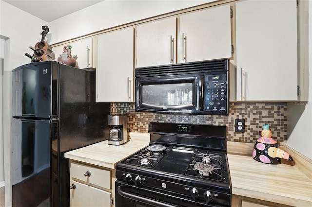 kitchen with wooden counters, backsplash, and black appliances