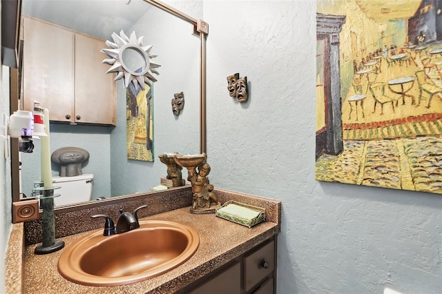 bathroom with a textured wall and vanity