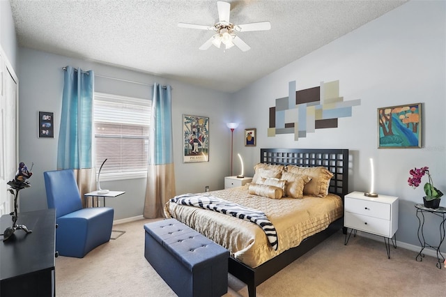 bedroom with a textured ceiling, light colored carpet, baseboards, and lofted ceiling