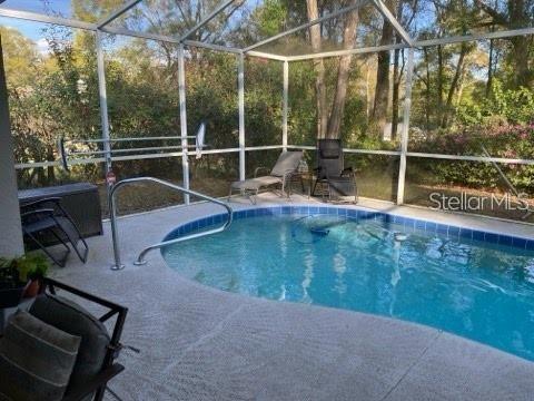 19430 SW 100th Loop, Dunnellon, FL 34432 - swimming pool with a lanai and a patio area