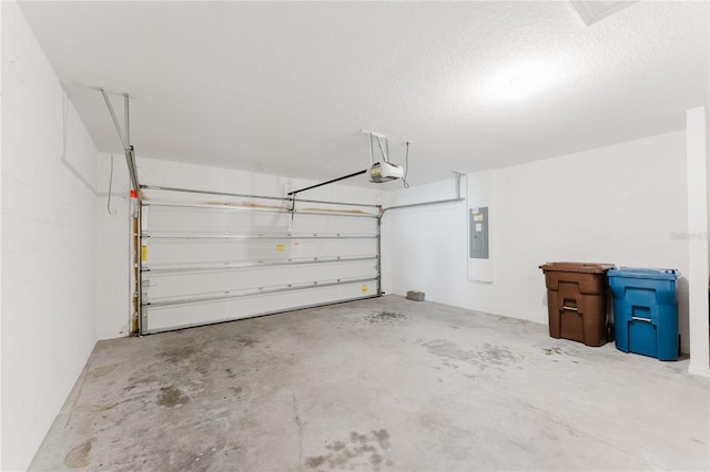 garage with electric panel and a garage door opener