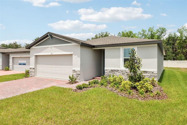 4717 Jasmine Cir, Leesburg, FL 34748 - ranch-style house with stone siding, decorative driveway, a garage, a front lawn, and stucco siding