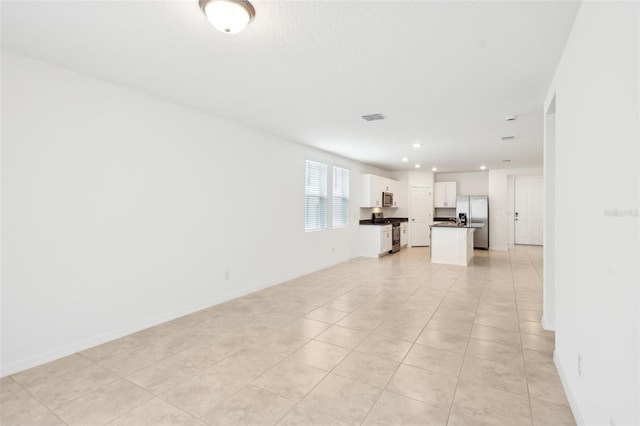 4717 Jasmine Cir, Leesburg, FL 34748 - unfurnished living room with baseboards, light tile patterned floors, and recessed lighting