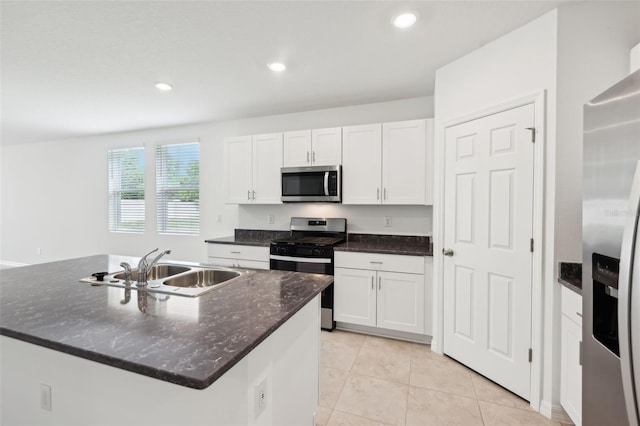 4717 Jasmine Cir, Leesburg, FL 34748 - kitchen featuring stainless steel appliances, a sink, white cabinetry, light tile patterned floors, and recessed lighting