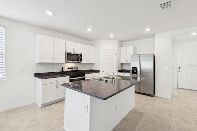 4717 Jasmine Cir, Leesburg, FL 34748 - kitchen featuring appliances with stainless steel finishes, a sink, white cabinetry, light tile patterned flooring, and baseboards