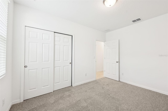 4717 Jasmine Cir, Leesburg, FL 34748 - unfurnished bedroom featuring carpet flooring, a closet, and baseboards